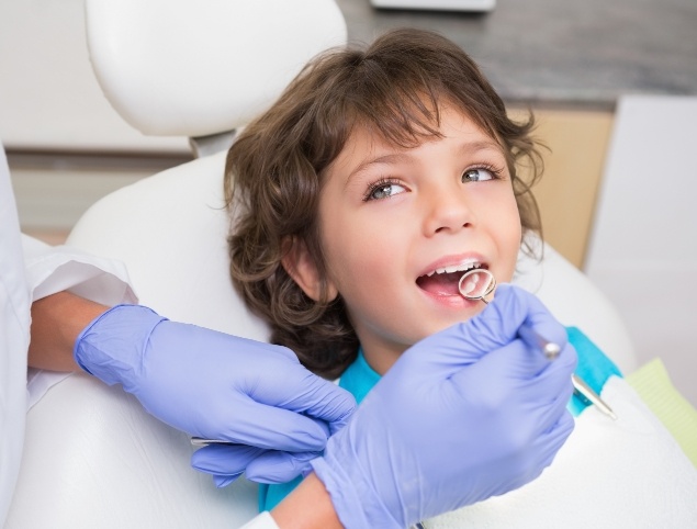 Young boy smiling during childrens dentistry appointment