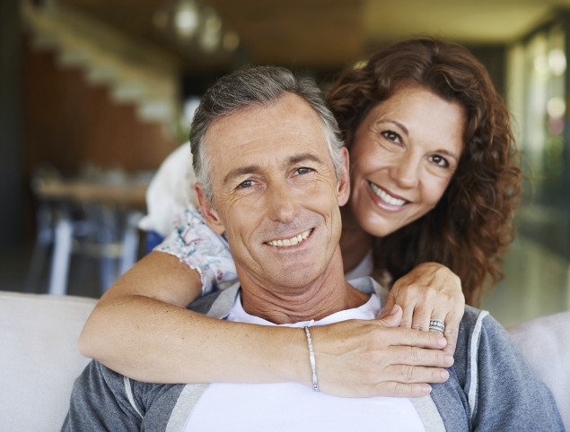 Man and woman smiling with dental implants in Topsham