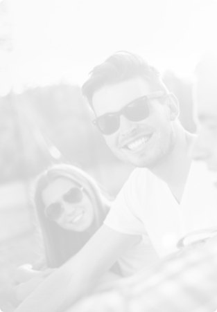 Man and woman in sunglasses smiling outdoors
