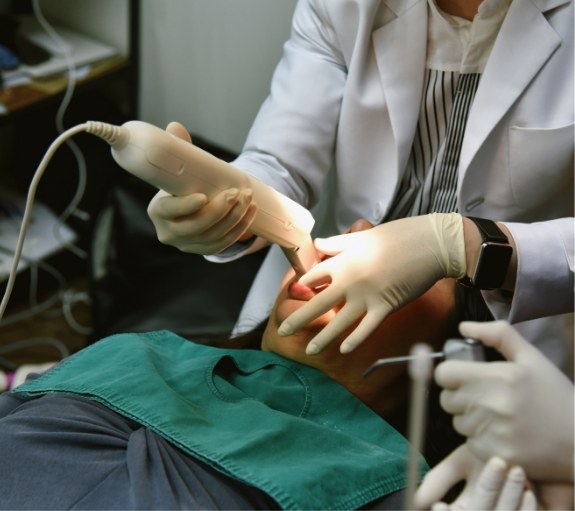 Dentist taking digital impressions of a patients teeth