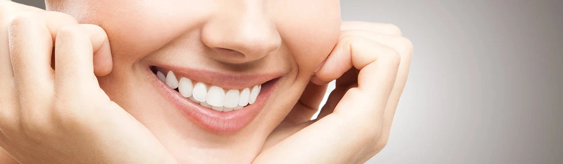 Dentist Topsham ME A Close Up of a Woman Smiling with Her Head Cradled in Her Hands Our Services A Close Up of a Woman Smiling with Her Head Cradled in Her Hands Our Services